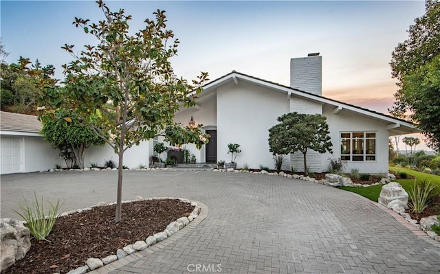 16 Roadrunner Rd, Rolling Hills, CA 90274 - view of front of home featuring curved driveway, a chimney, and stucco siding