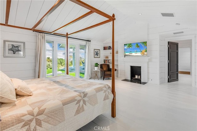 16 Roadrunner Rd, Rolling Hills, CA 90274 - bedroom with lofted ceiling, a fireplace, access to outside, and wood walls