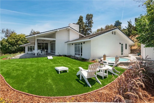16 Roadrunner Rd, Rolling Hills, CA 90274 - rear view of property with a chimney, a patio, a yard, and stucco siding