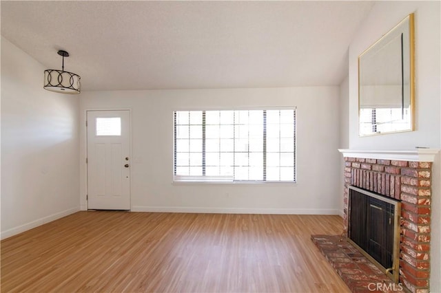 1714 Evelyn Pl, Palmdale, CA 93550 - unfurnished living room with light wood-type flooring and a fireplace