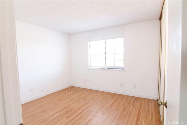 1714 Evelyn Pl, Palmdale, CA 93550 - unfurnished room with light wood finished floors and a textured ceiling