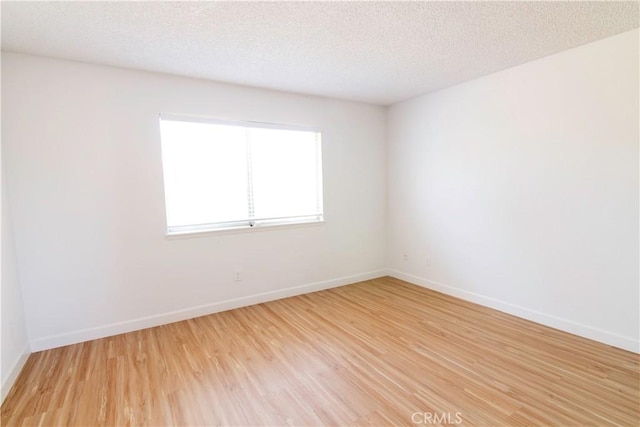 1714 Evelyn Pl, Palmdale, CA 93550 - empty room featuring light wood-style flooring and a textured ceiling