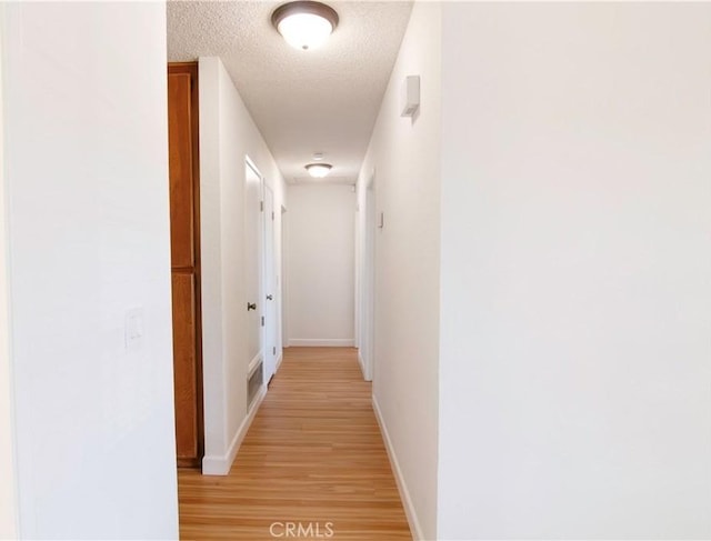 1714 Evelyn Pl, Palmdale, CA 93550 - hallway featuring light wood-style floors and a textured ceiling