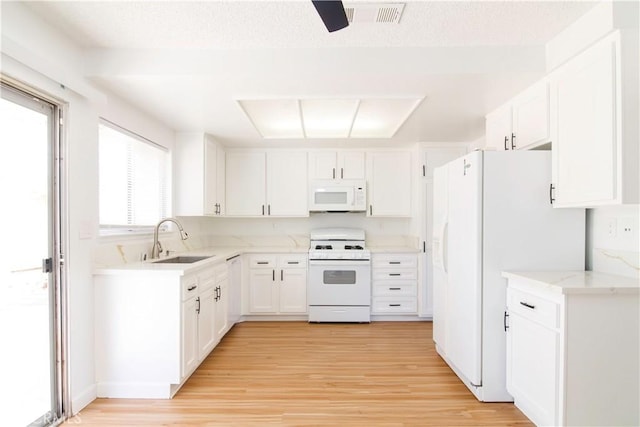 1714 Evelyn Pl, Palmdale, CA 93550 - kitchen featuring white appliances, light wood finished floors, white cabinets, light stone counters, and ceiling fan