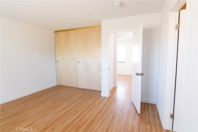 1714 Evelyn Pl, Palmdale, CA 93550 - unfurnished bedroom with light wood finished floors, a closet, and a textured ceiling