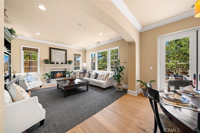 19668 Three Oaks Ln, Walnut, CA 91789 - living room with arched walkways, light wood-type flooring, ornamental molding, a glass covered fireplace, and recessed lighting