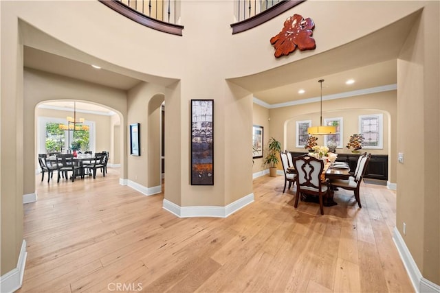 19668 Three Oaks Ln, Walnut, CA 91789 - foyer entrance featuring arched walkways, light wood finished floors, a chandelier, recessed lighting, and crown molding