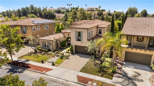 19668 Three Oaks Ln, Walnut, CA 91789 - view of front facade featuring an attached garage, concrete driveway, stucco siding, and a tiled roof