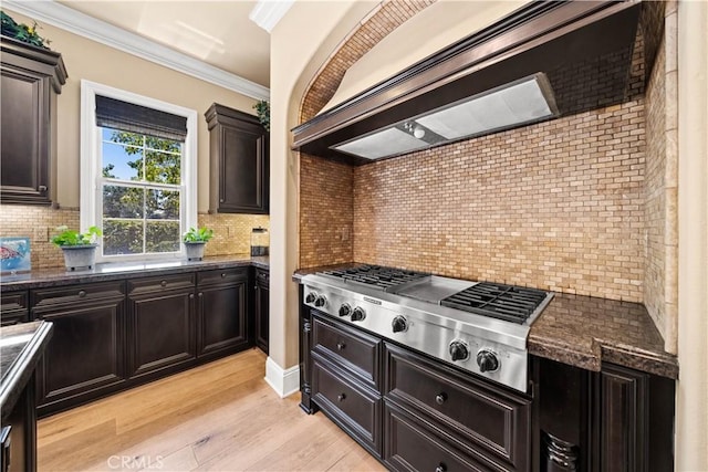 19668 Three Oaks Ln, Walnut, CA 91789 - kitchen with stainless steel gas cooktop, light wood-type flooring, tasteful backsplash, crown molding, and dark stone counters