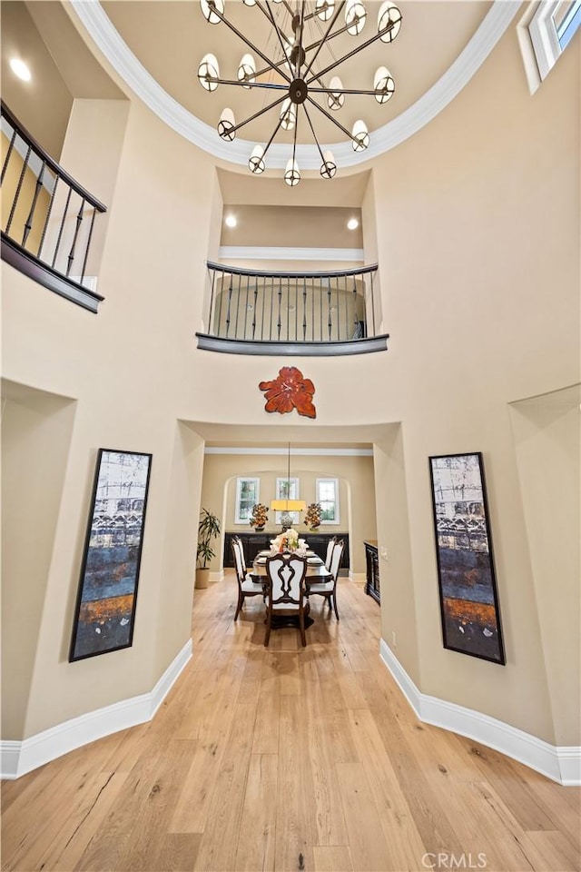 19668 Three Oaks Ln, Walnut, CA 91789 - dining space featuring a chandelier, hardwood / wood-style floors, ornamental molding, and a high ceiling