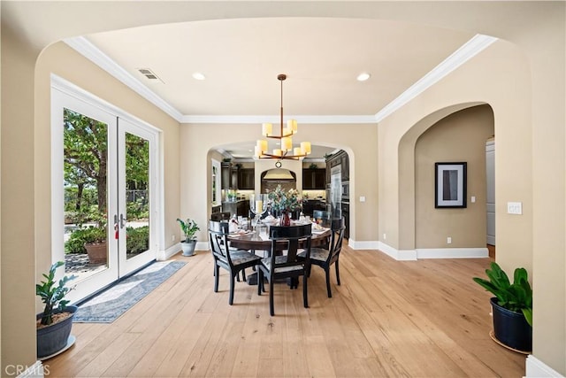 19668 Three Oaks Ln, Walnut, CA 91789 - dining room featuring a chandelier, french doors, light wood finished floors, arched walkways, and ornamental molding
