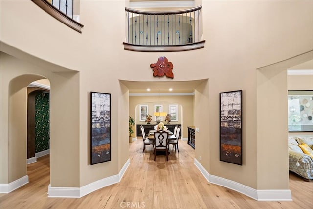 19668 Three Oaks Ln, Walnut, CA 91789 - hallway with arched walkways, wood finished floors, plenty of natural light, and a high ceiling
