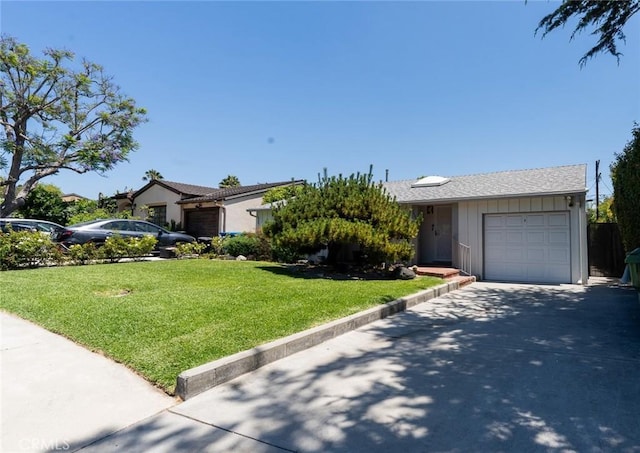 3456 Veteran Ave, Los Angeles, CA 90034 - view of front facade featuring a garage, driveway, a front yard, and board and batten siding