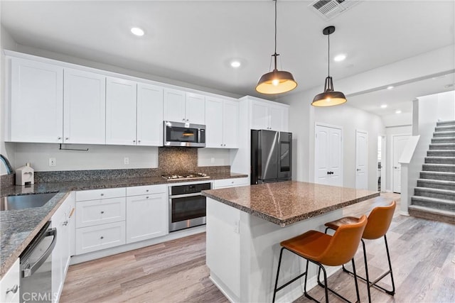 16004 Huckleberry Ave, Chino, CA 91708 - kitchen featuring stainless steel appliances, light wood finished floors, white cabinetry, and recessed lighting