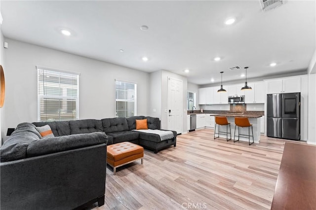16004 Huckleberry Ave, Chino, CA 91708 - living room with recessed lighting and light wood-style flooring