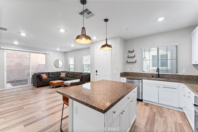 16004 Huckleberry Ave, Chino, CA 91708 - kitchen with dishwasher, light wood-style flooring, white cabinetry, plenty of natural light, and recessed lighting