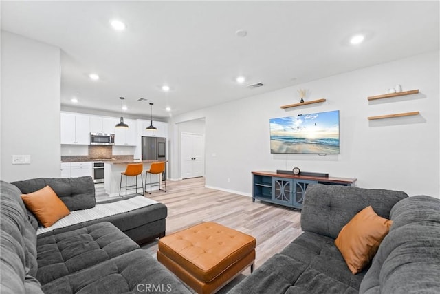 16004 Huckleberry Ave, Chino, CA 91708 - living area featuring light wood-type flooring and recessed lighting