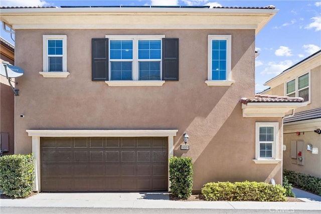 16004 Huckleberry Ave, Chino, CA 91708 - view of front of home featuring a garage, a tile roof, and stucco siding