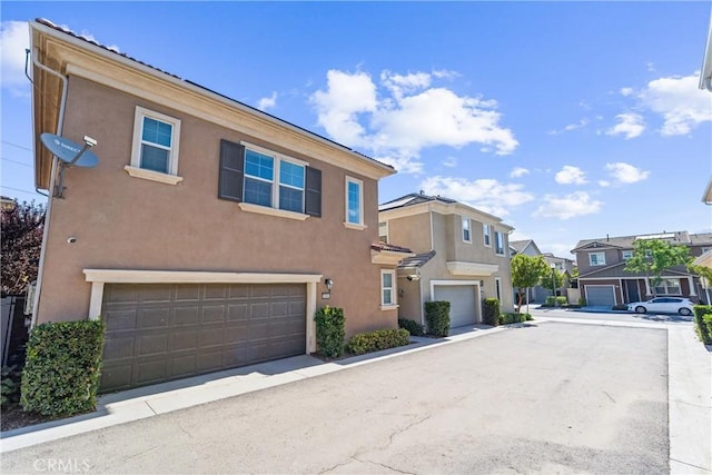 16004 Huckleberry Ave, Chino, CA 91708 - view of front of home with stucco siding, a residential view, and a garage