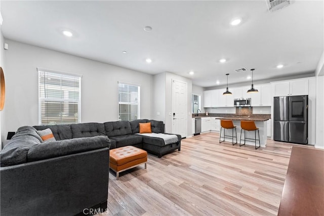 16004 Huckleberry Ave, Chino, CA 91708 - living area with recessed lighting and light wood-style flooring