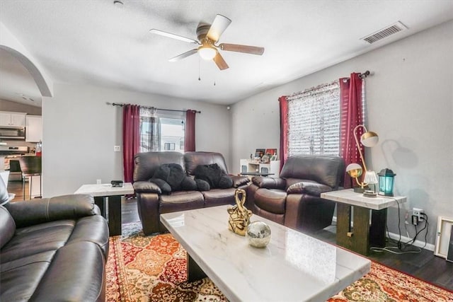 17993 Mondamon Rd, Apple Valley, CA 92307 - living room with arched walkways, wood finished floors, and a ceiling fan