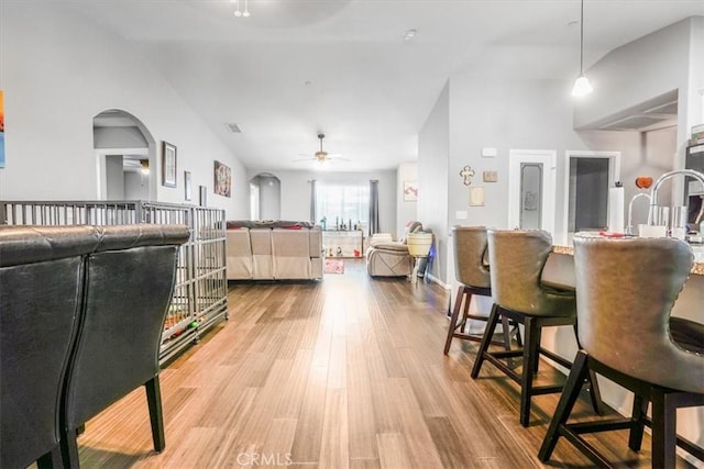 17993 Mondamon Rd, Apple Valley, CA 92307 - living room featuring a ceiling fan, wood finished floors, arched walkways, and vaulted ceiling