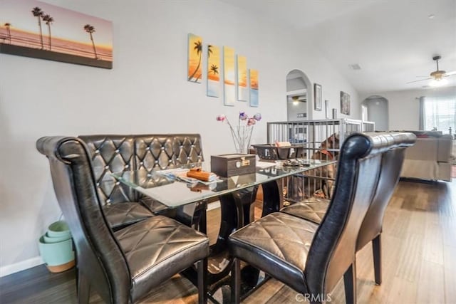 17993 Mondamon Rd, Apple Valley, CA 92307 - dining space with arched walkways, wood finished floors, and a ceiling fan