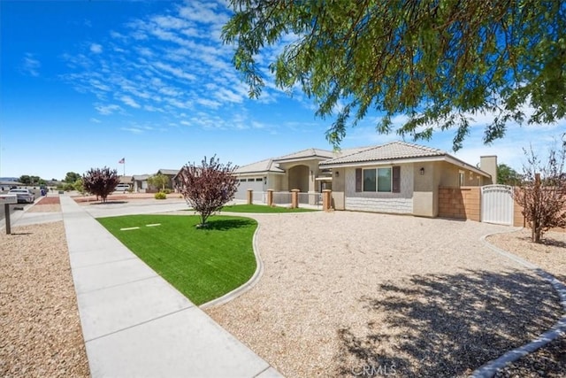 17993 Mondamon Rd, Apple Valley, CA 92307 - ranch-style house featuring a gate, stucco siding, and a tiled roof