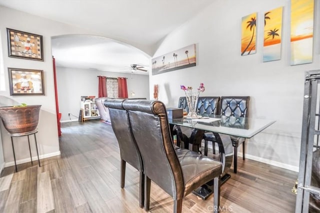 17993 Mondamon Rd, Apple Valley, CA 92307 - dining space featuring arched walkways, wood finished floors, ceiling fan, and lofted ceiling