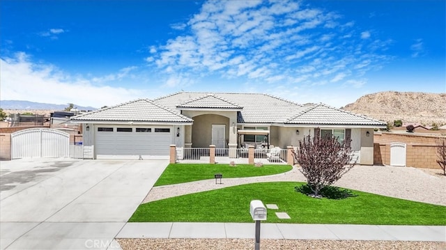 17993 Mondamon Rd, Apple Valley, CA 92307 - view of front of property featuring stucco siding, a gate, driveway, and a garage