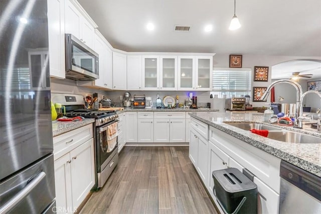 17993 Mondamon Rd, Apple Valley, CA 92307 - kitchen featuring appliances with stainless steel finishes, ceiling fan, white cabinets, and glass insert cabinets