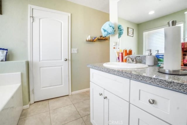 17993 Mondamon Rd, Apple Valley, CA 92307 - bathroom with vanity, a garden tub, and tile patterned flooring