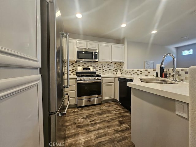 11 Emory Unit 85, Irvine, CA 92602 - kitchen with appliances with stainless steel finishes, dark wood finished floors, tasteful backsplash, light countertops, and recessed lighting