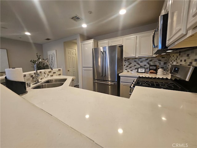 11 Emory Unit 85, Irvine, CA 92602 - kitchen with stainless steel appliances, decorative backsplash, light countertops, recessed lighting, and white cabinets