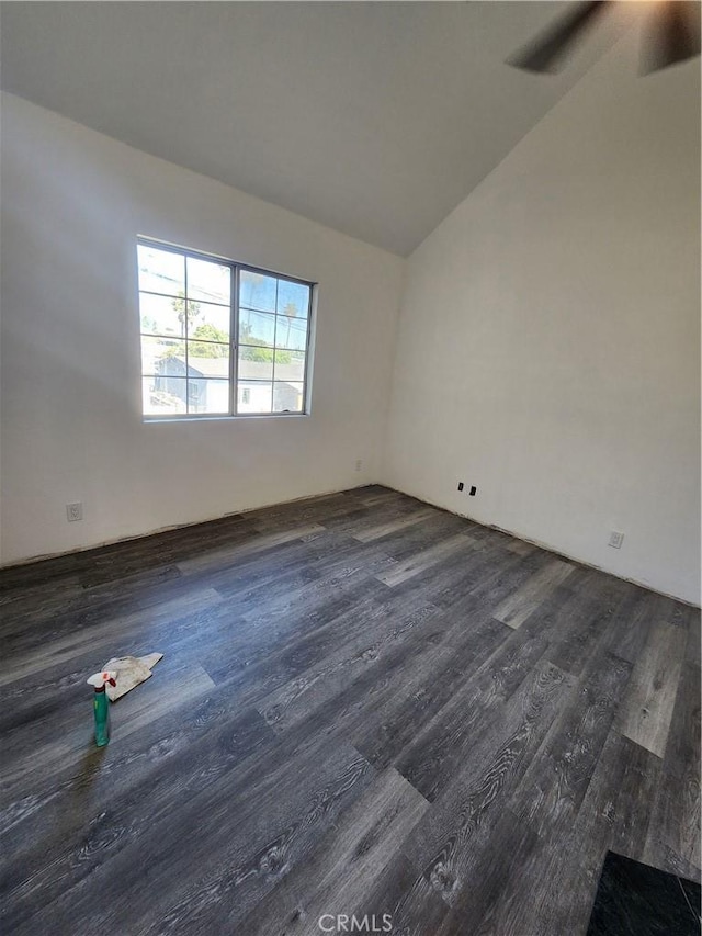 700 E Compton Blvd, Rancho Dominguez, CA 90220 - spare room featuring dark wood-type flooring, vaulted ceiling, and a ceiling fan