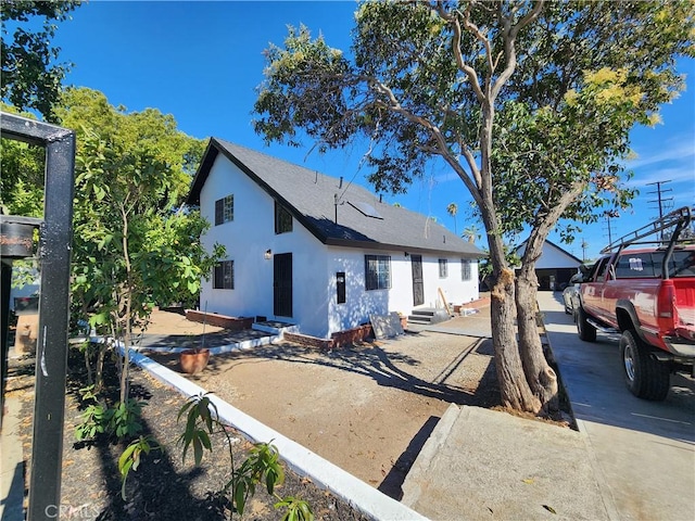700 E Compton Blvd, Rancho Dominguez, CA 90220 - view of front of home featuring entry steps, stucco siding, and roof with shingles
