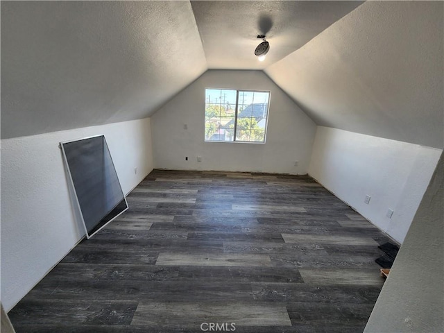 700 E Compton Blvd, Rancho Dominguez, CA 90220 - bonus room featuring a textured ceiling, lofted ceiling, and dark wood finished floors
