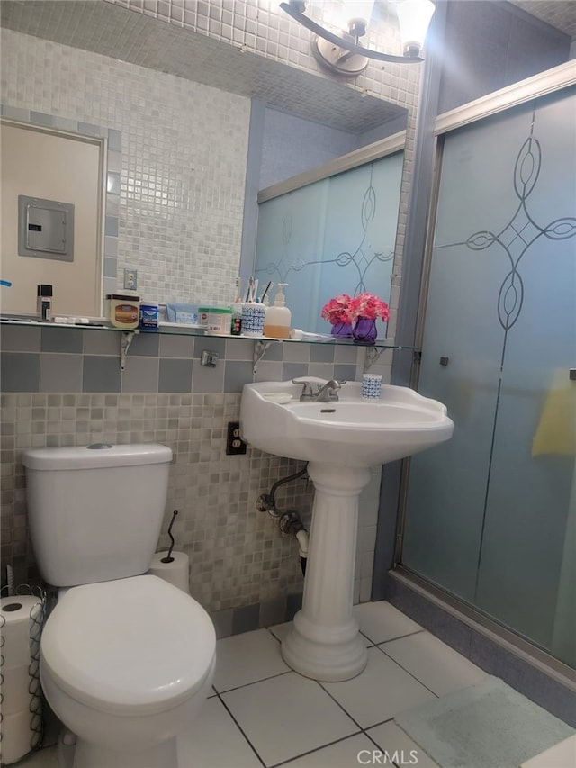 8502 Borson St, Downey, CA 90242 - bathroom featuring tile walls, a shower stall, and tile patterned floors