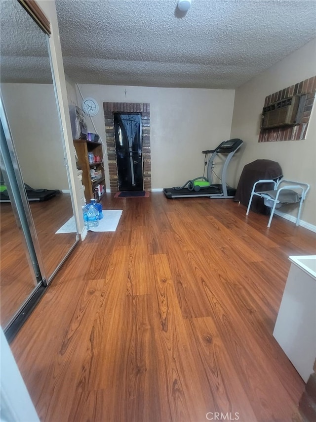 8502 Borson St, Downey, CA 90242 - exercise room featuring wood finished floors and a textured ceiling