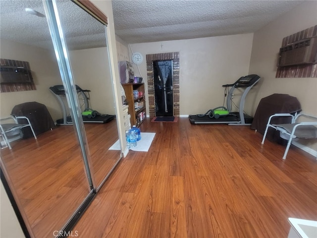 8502 Borson St, Downey, CA 90242 - workout area with wood finished floors, a textured ceiling, and a wall unit AC