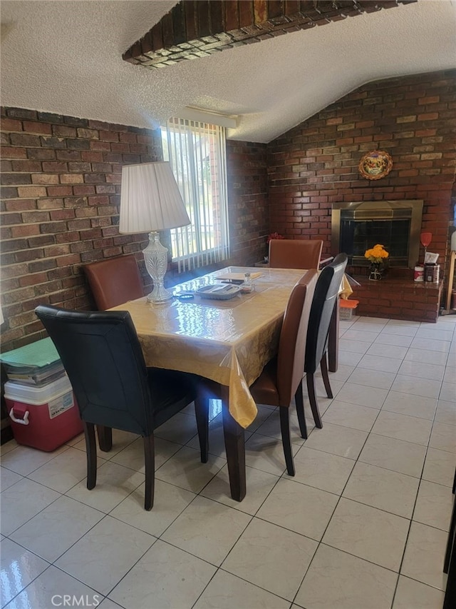 8502 Borson St, Downey, CA 90242 - dining area featuring a textured ceiling, light tile patterned floors, brick wall, a fireplace, and lofted ceiling