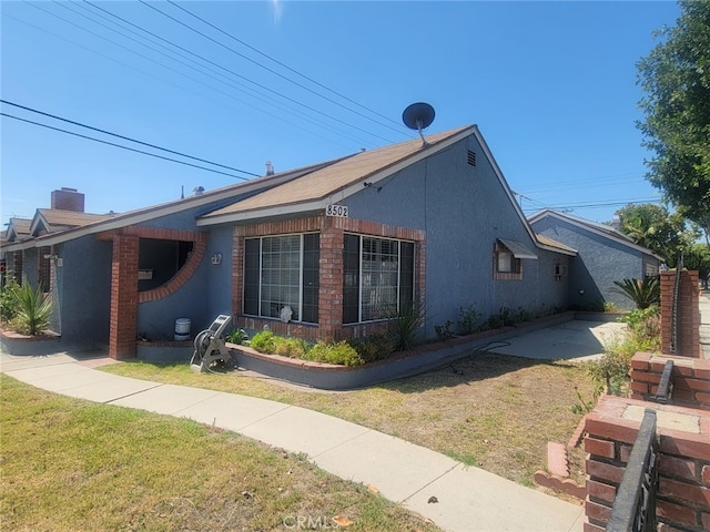 8502 Borson St, Downey, CA 90242 - view of side of property featuring a yard and stucco siding