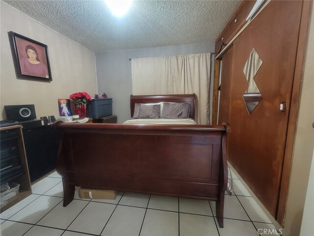 8502 Borson St, Downey, CA 90242 - bedroom with a textured ceiling and light tile patterned flooring