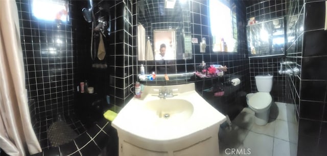 8502 Borson St, Downey, CA 90242 - bathroom with tile walls, tile patterned flooring, and vanity