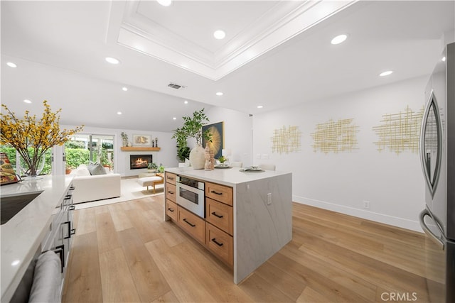 12 Creekside, Irvine, CA 92603 - kitchen featuring stainless steel appliances, recessed lighting, light wood-style floors, a raised ceiling, and open floor plan
