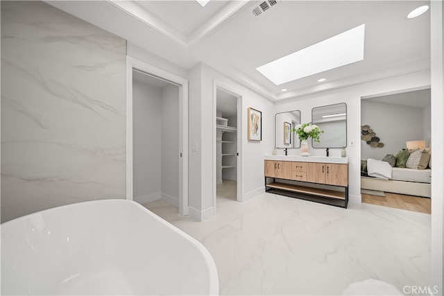 12 Creekside, Irvine, CA 92603 - ensuite bathroom with a skylight, double vanity, a freestanding bath, a walk in closet, and recessed lighting