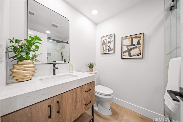 12 Creekside, Irvine, CA 92603 - bathroom featuring vanity, a marble finish shower, and wood finished floors