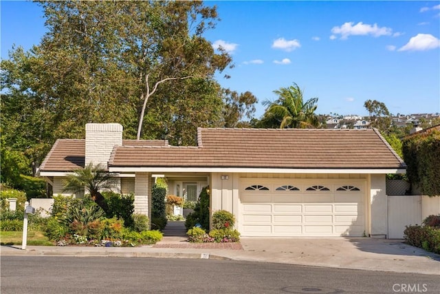 12 Creekside, Irvine, CA 92603 - ranch-style house with concrete driveway, a garage, and a chimney