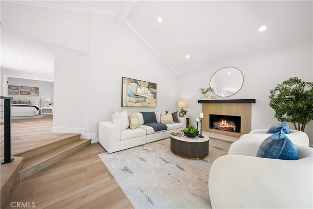 12 Creekside, Irvine, CA 92603 - living area featuring a warm lit fireplace, wood finished floors, ornamental molding, recessed lighting, and high vaulted ceiling