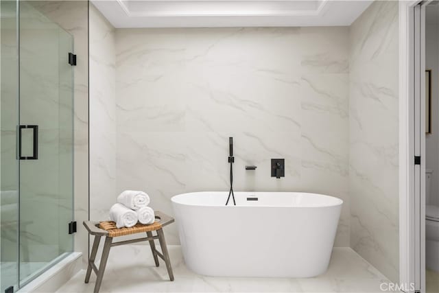 12 Creekside, Irvine, CA 92603 - bathroom with a freestanding bath, a marble finish shower, tile walls, and marble finish flooring